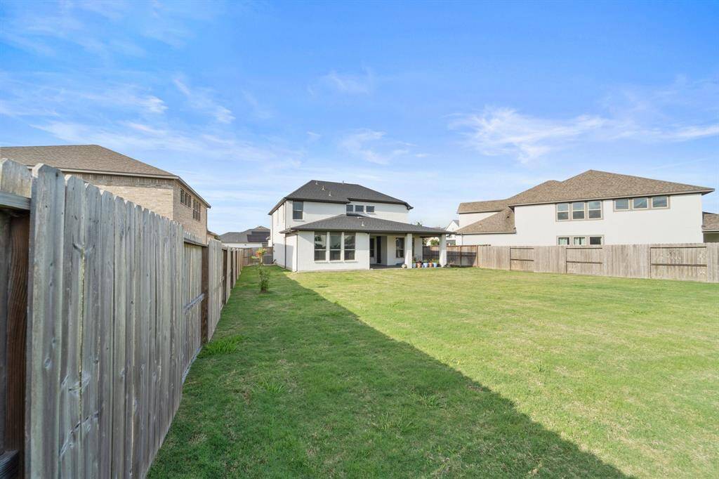 This expansive yard is ideal for entertaining or adding a pool, with ample space between homes and no rear neighbors in sight.