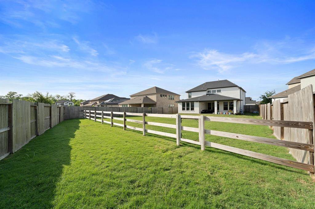 Fully fenced with both privacy and ranch-style fencing, the backyard provides safety, space, and serene views.