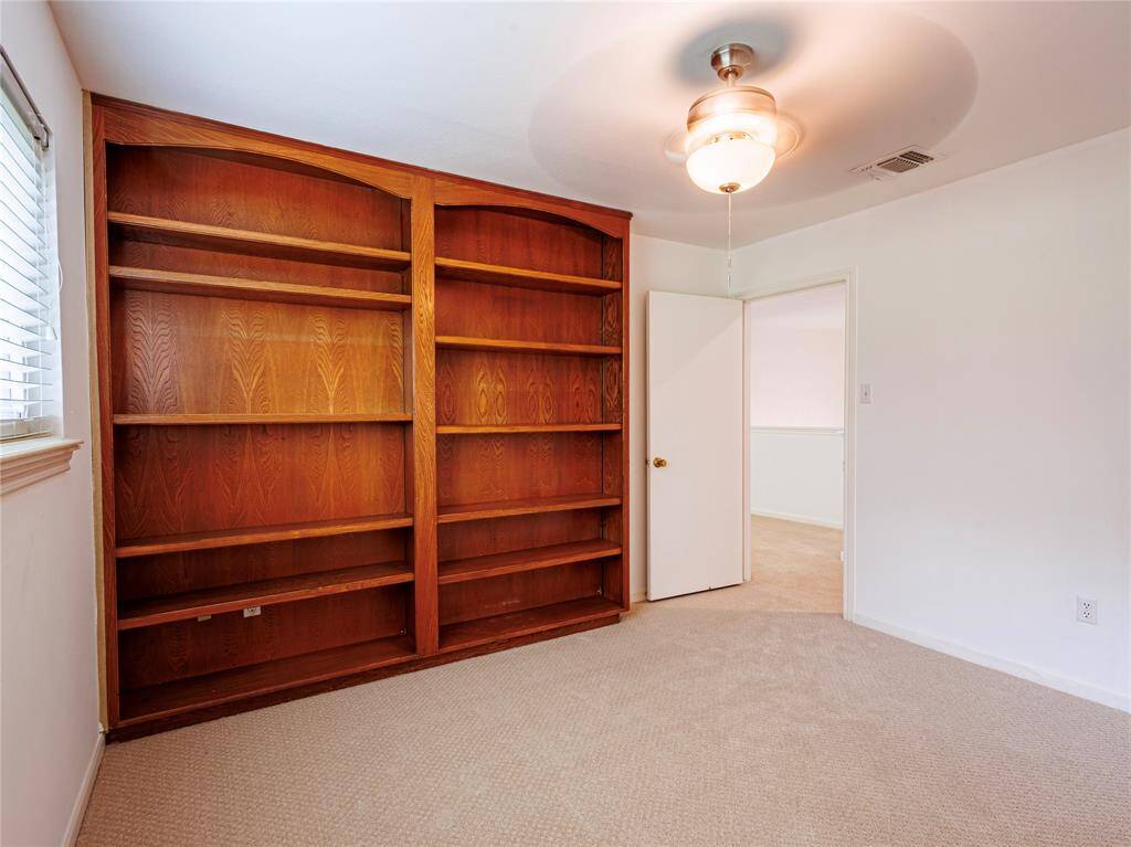 Middle bedroom has wall of built-ins.