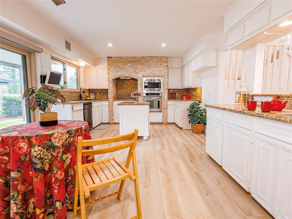 Updated eat-in kitchen with stainless steel appliances and new flooring.