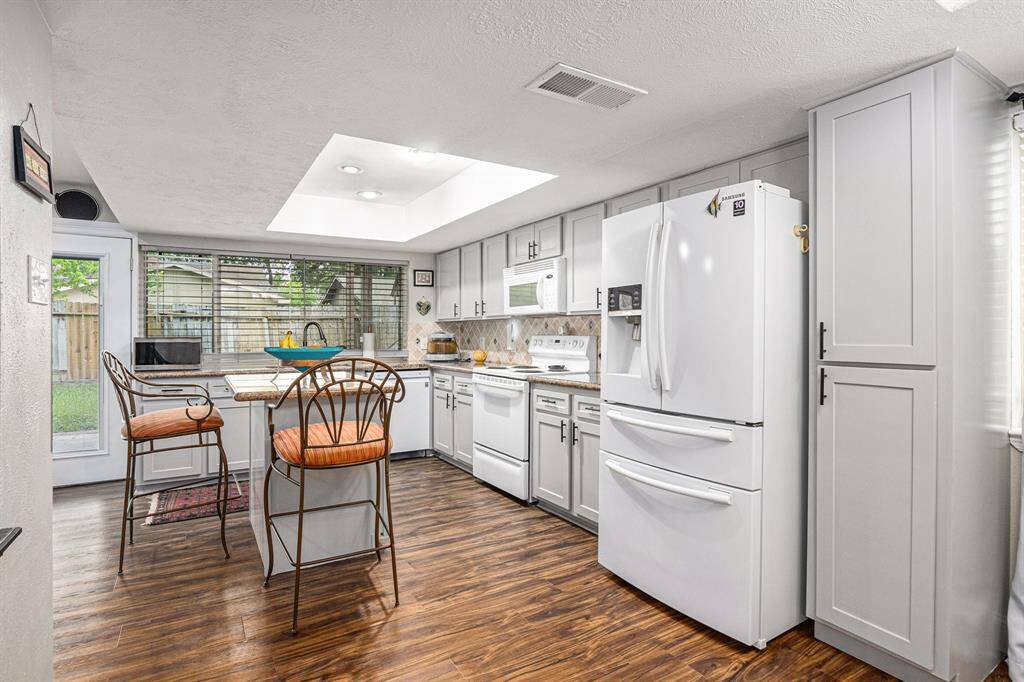 Bright and airy kitchen equipped with the refrigerator
