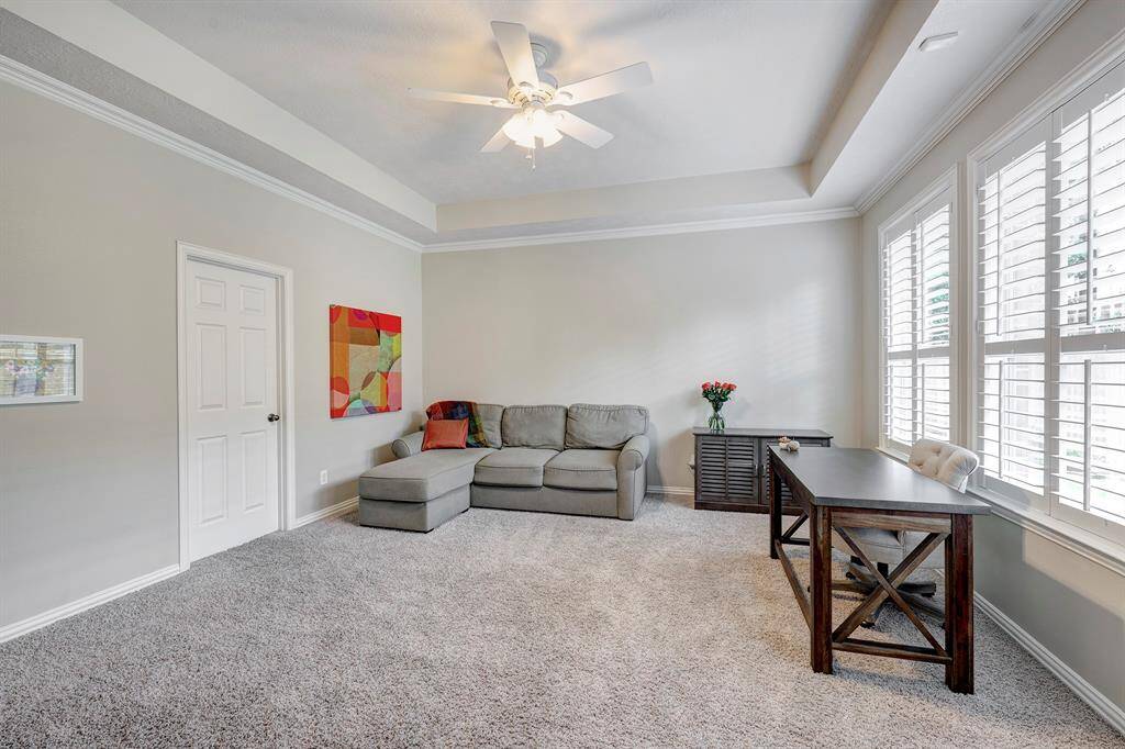 One of TWO primary bedrooms! This one is on the first floor and has a tray ceiling, great natural light and ensuite bath