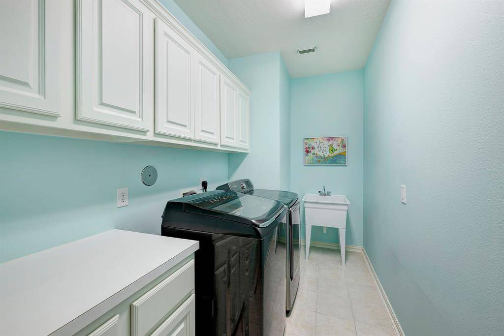 Spacious laundry room with sink
