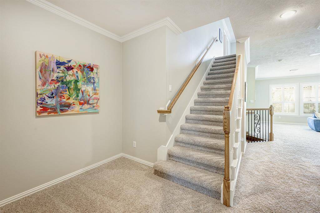 Staircase to fifth bedroom on third floor with the gameroom in the background