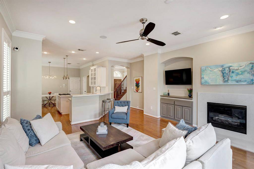 Living room with view of fireplace and built-in entertainment nook
