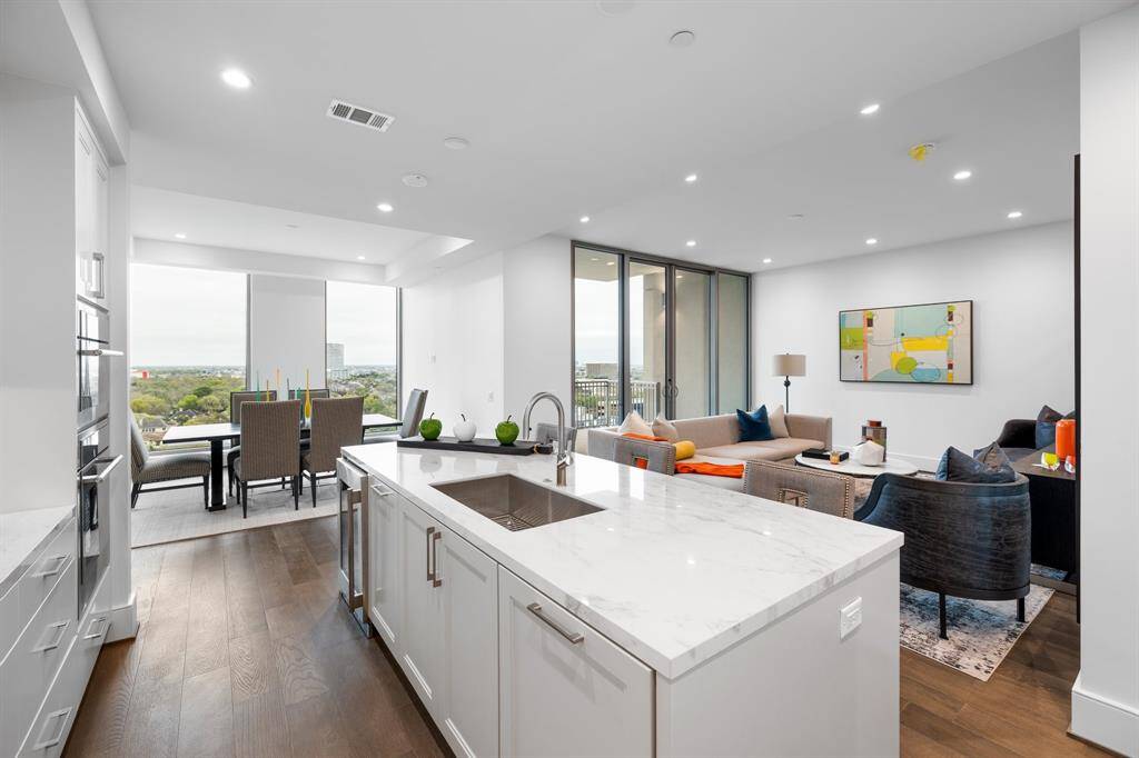View of the kitchen, living room and dining room.
