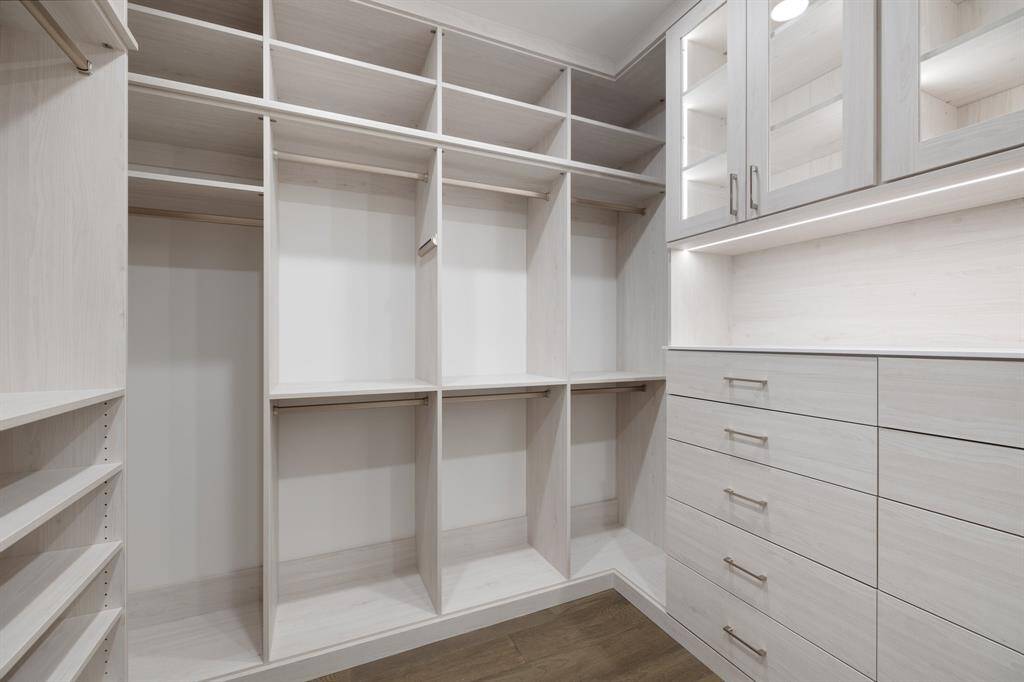Closet with built-in shelving and drawers.