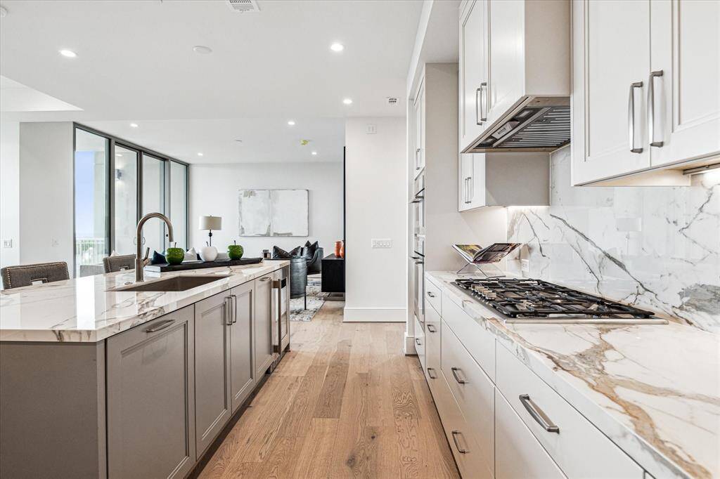Stunning chef’s kitchen boasts sleek, modern design paired with top-of-the-line functionality.