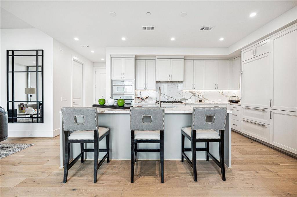 The oversized center island features a built-in sink, and breakfast bar seating.