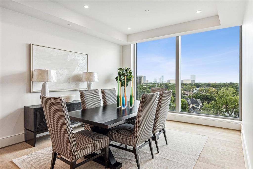 Floor-to-ceiling windows in the formal dining area flood the space with natural light and showcase stunning city Southern views