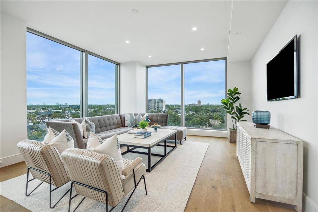 Floor-to-ceiling windows showcase panoramic Northern views of the city.
