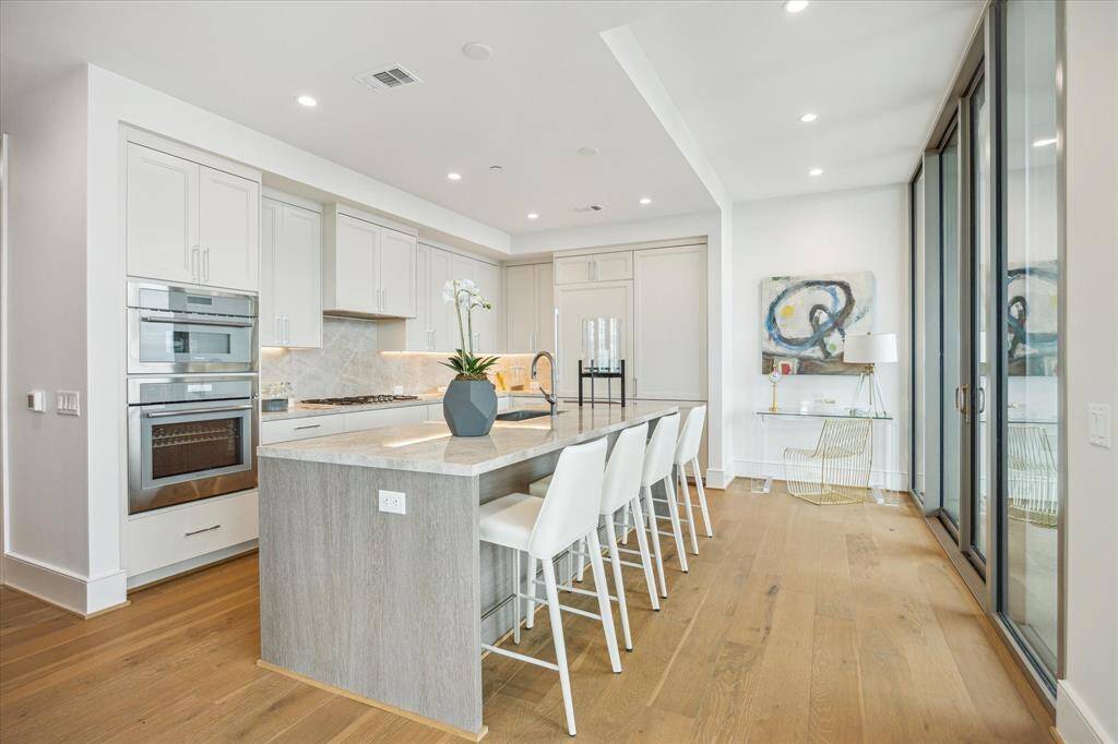 Stunning chef’s kitchen with elegant modern design and custom -built soft-closing cabinetry and drawers