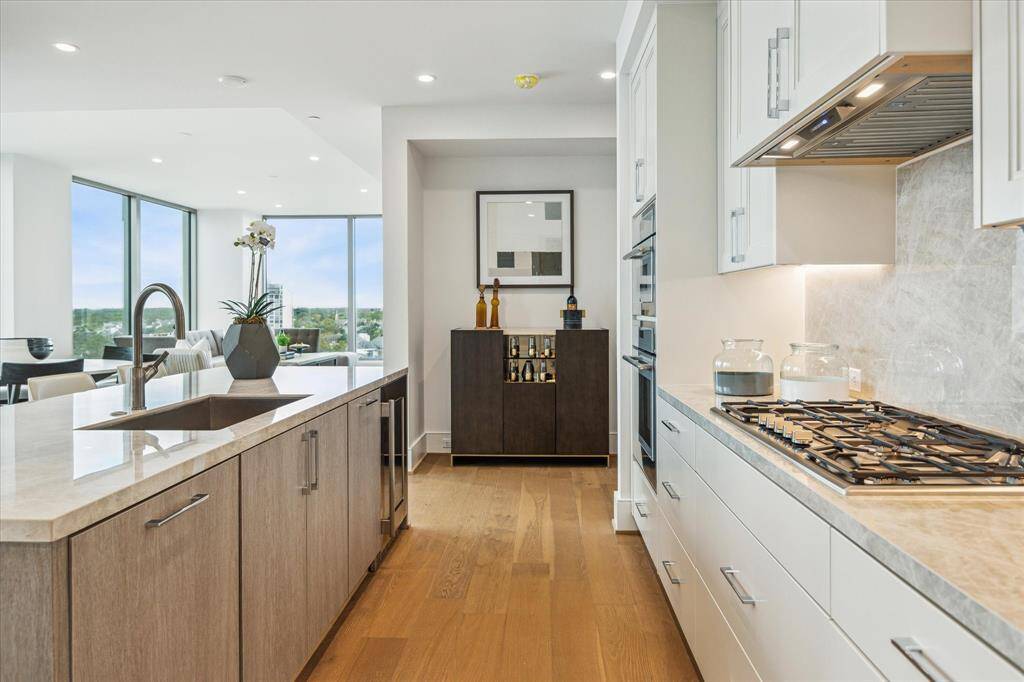 Alternate view of the kitchen with gorgeous porcelain counter-top and a space for a future built-in bar