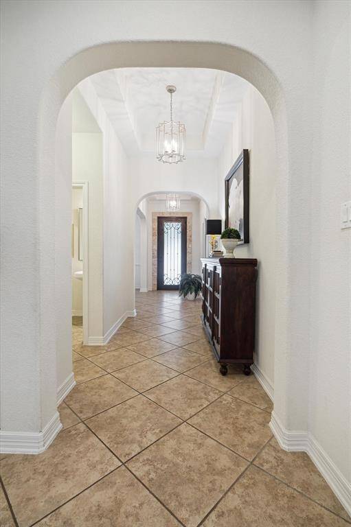 The entry way features high ceilings and leads to a large open kitchen and living area with an oversized island, a flex space, plus rare finds like a game room and media room.