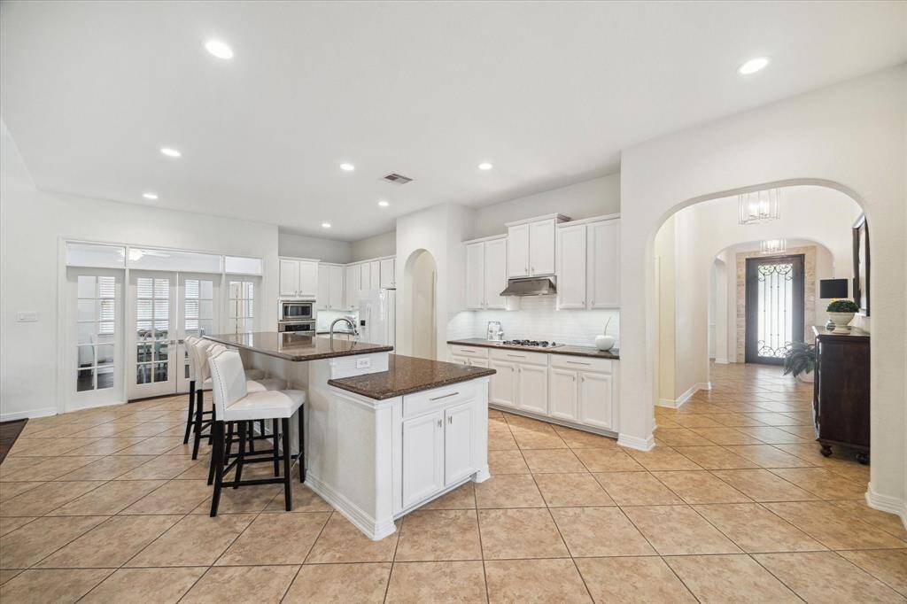 Whether you’re prepping dinner or pouring coffee, the open layout keeps you fully engaged with everything happening in the main living space. With sightlines that extend into the living room and out to the backyard, the kitchen truly anchors the home’s flow and functionality.