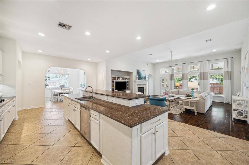 Whether you’re prepping dinner or pouring coffee, the open layout keeps you fully engaged with everything happening in the main living space. With sightlines that extend into the living room and out to the backyard, the kitchen truly anchors the home’s flow and functionality.