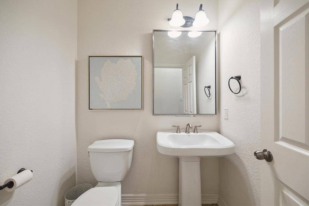 The half-bath is located near the front of the home close to the main living areas and convenient for guests.