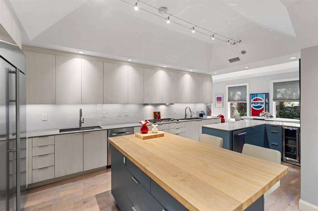 A view of the kitchen featuring Silestone countertops, dual stainless steel sinks, and stylish tile backsplash. French door oven, microwave/convection oven and warming drawer too.
