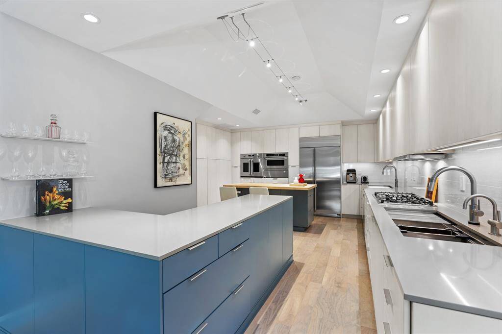 The spacious kitchen layout includes double sinks, under-cabinet lighting, and opens into the Family and Breakfast Rooms.