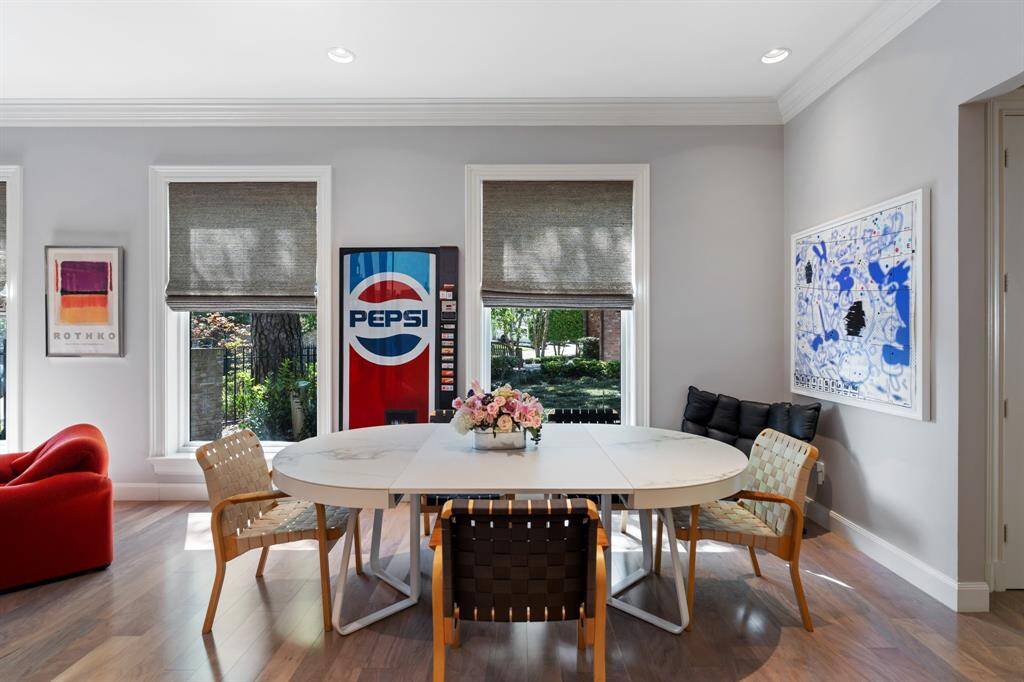 The generous sized Breakfast Room with hardwood floor, deep baseboards, and large windows overlook the side yard and patio.