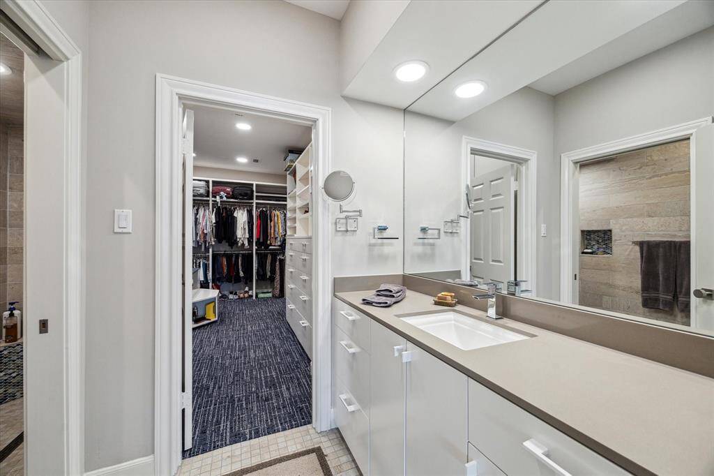 One of the two full baths in the Primary Suite.  This bath is home to a large shower, private toilet space, large silestone vanity and opens to the custom closet fit for royalty.