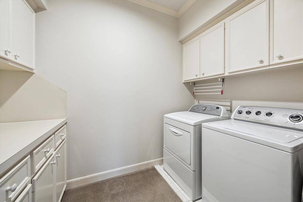 Wonderful Laundry/Utility Room with ceramic tile flooring, upper and lower cabinets and drawers, laminate counter, and full-size washer/dryer. The Laundry/Utility Room is located upstairs near the bedrooms for convenience.