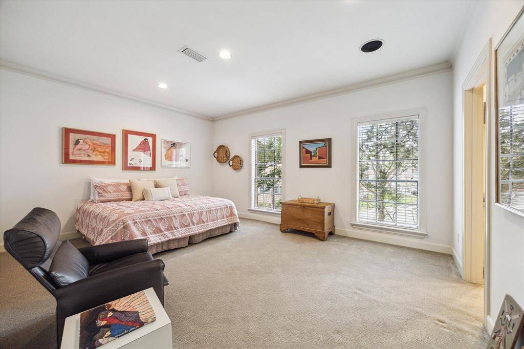 Bedroom 2 with crown molding, carpet, recessed lighting, and windows facing west overlooking the side yard.