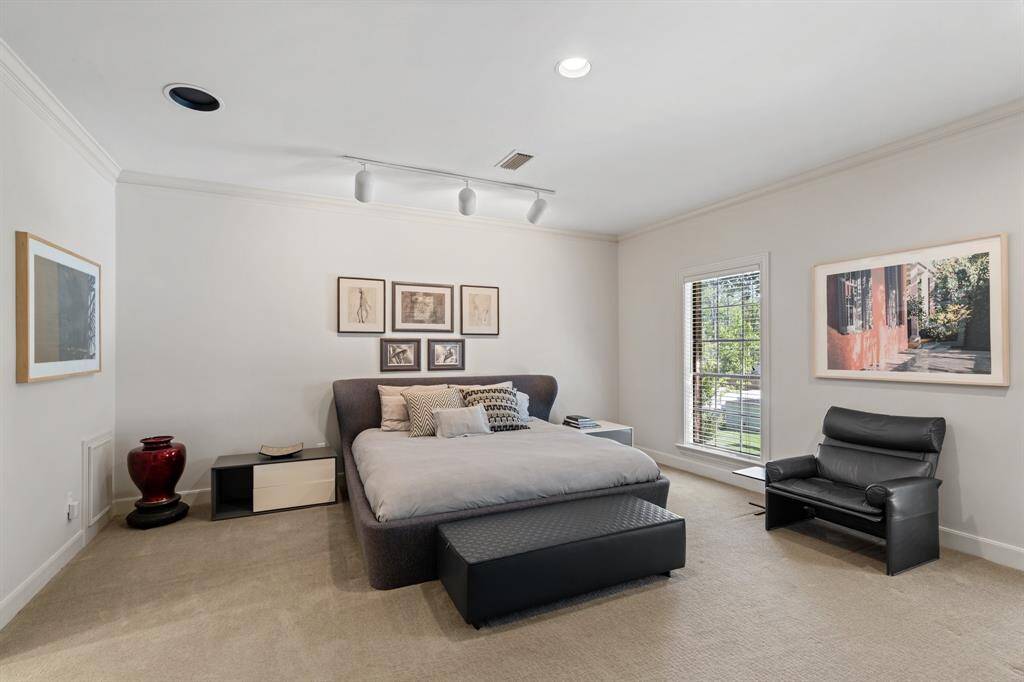 Bedroom 3 with crown molding, carpet, recessed lighting, and two divided light windows facing south overlooking the front drive.