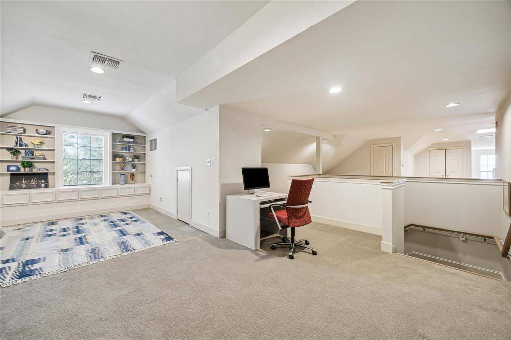 The third-floor office/Game Room includes built-in drawers, adjustable shelves, and recessed/track lighting throughout. There is also a studio space on the other side of the staircase.