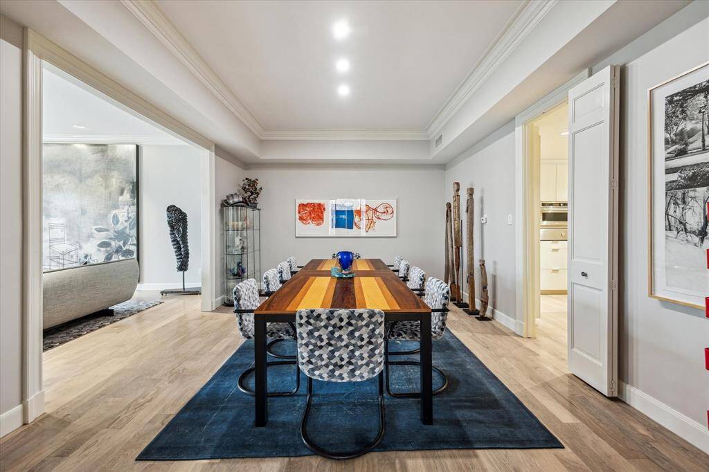 A view of the Dining Room showcasing the large cased opening to the Entry and natural light from the adjacent Living Room. The first floor living areas flow seamlessly from the Living Room to the Dining Room to the Kitchen.