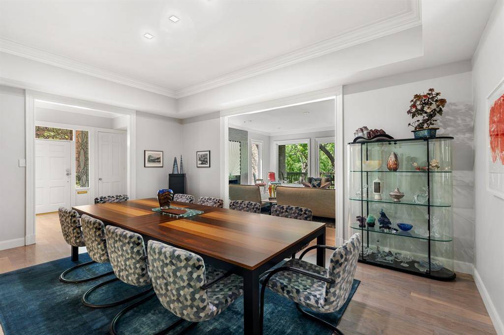 The Dining Room as viewed from the Entry and through to the Living Room.  Note the large windows in the Living Room with gorgeous treed views.  The Dining Room also opens to the Kitchen (out of view).