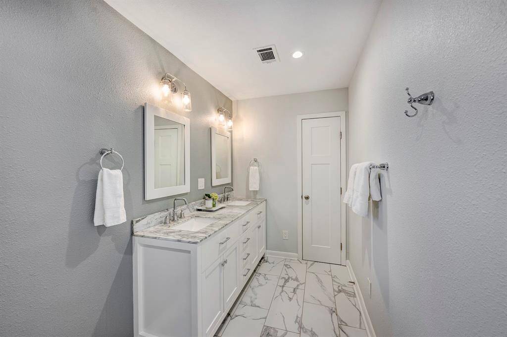 Light and bright expanded primary bath with double vanity, extra linen closet and plenty of space to add a soaking tub