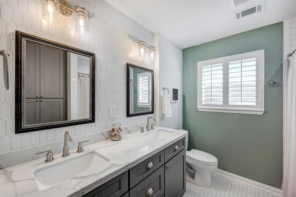 Secondary bath with quartz countertops and double vanity