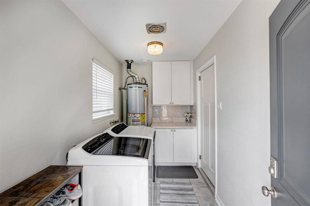 Utility room with built-in cabinets and quartz countertop