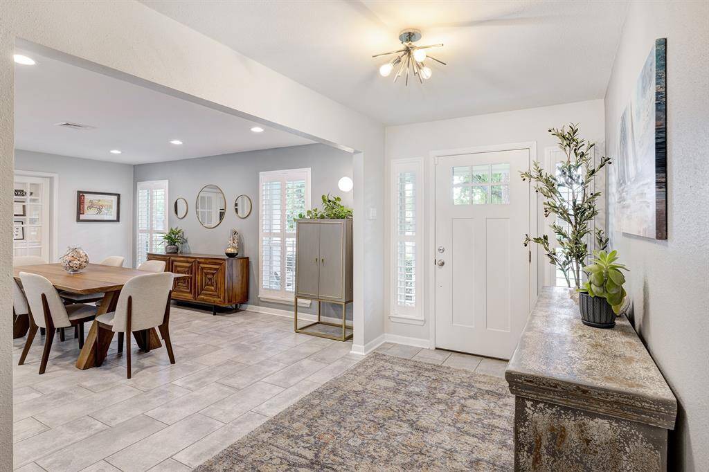Inviting entryway with tile floors and designer light fixtures