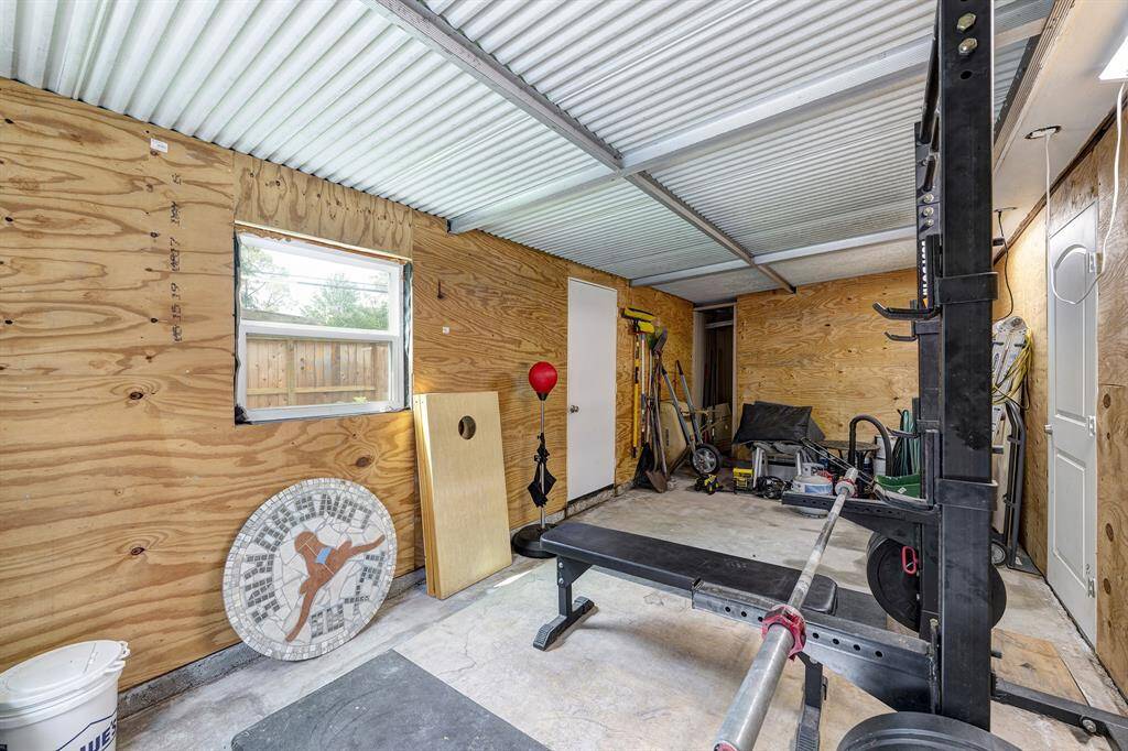 Extra shed built onto the back of the garage for whatever suits your needs. Seller is willing to sell gym equipment.