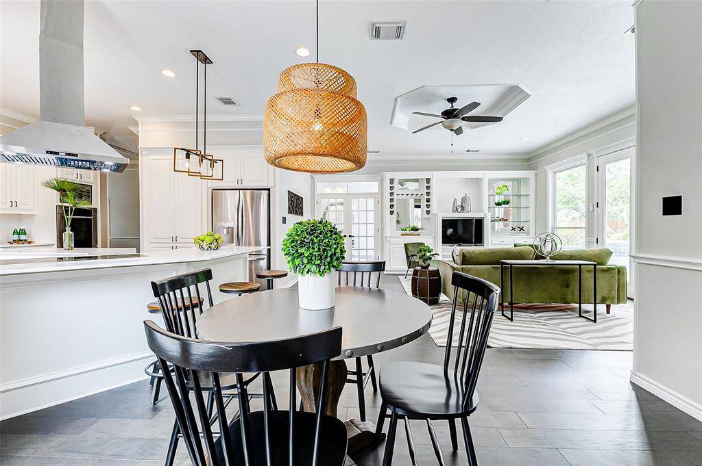 The spacious breakfast area is overlooking the open floor plan informal living room and kitchen.