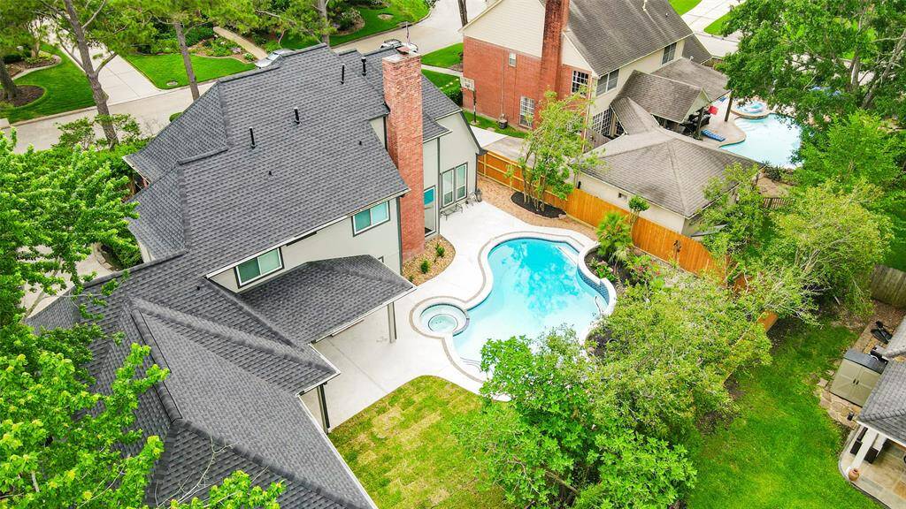 Spacious home with a unique, curvy swimming pool in a well-landscaped backyard. The property features a brand new roof and a cozy outdoor area, surrounded by lush greenery and new fence. Ideal for those seeking a blend of comfort and outdoor leisure.
