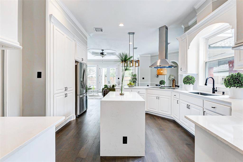 A view of the stylish kitchen from the laundry room. Perfect for those who love spacious and stylish cooking spaces.