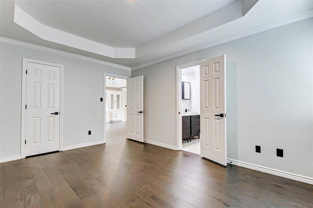 The 2nd of the secondary bedrooms with light gray walls, and a tray ceiling is also connected to the Jack & Jill bathroom.