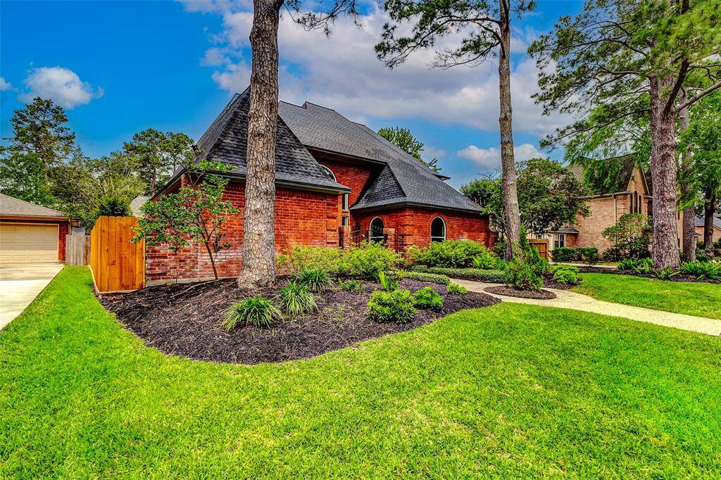 A classic design with new fence, a manicured lawn and mature trees, creating a welcoming and picturesque setting.