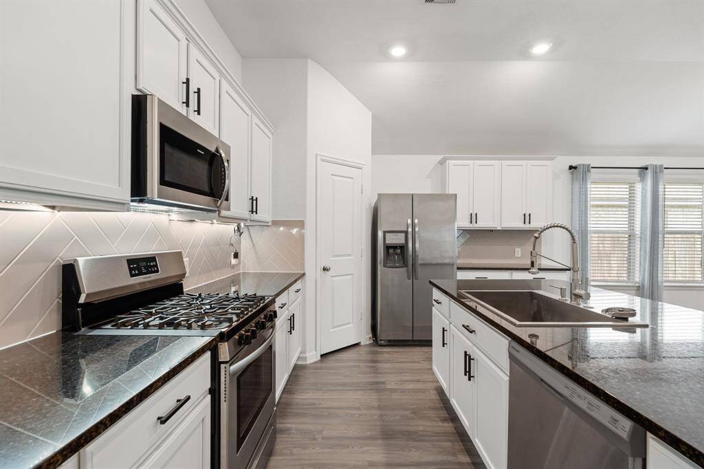 Kitchen, complete with under cabinet lighting and large farm sink.