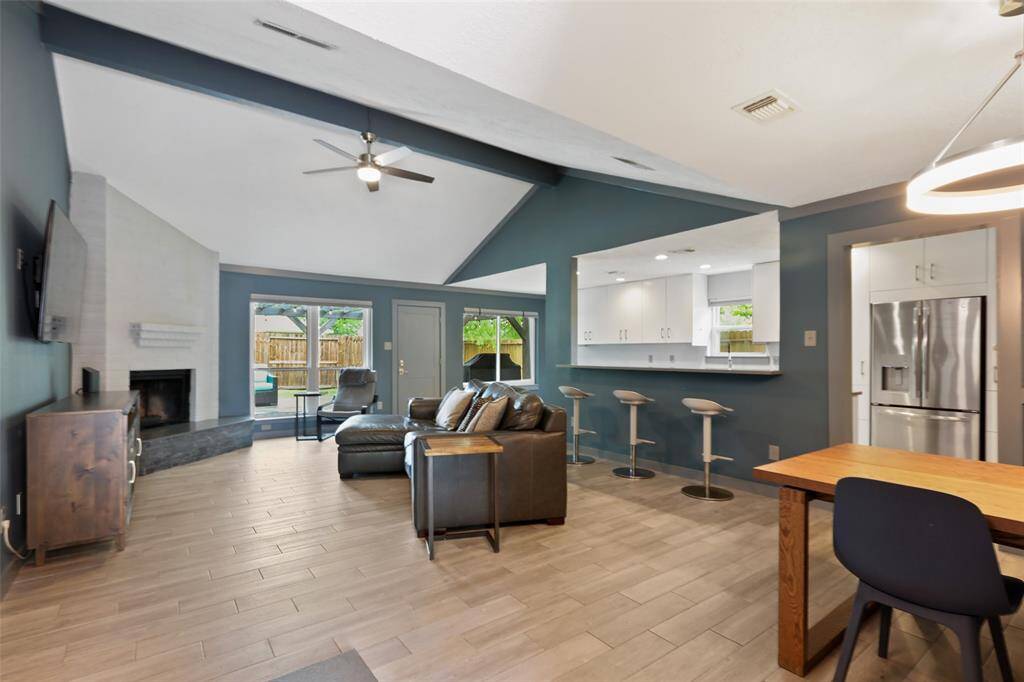 The spacious living space is open concept with a high vaulted ceilging.