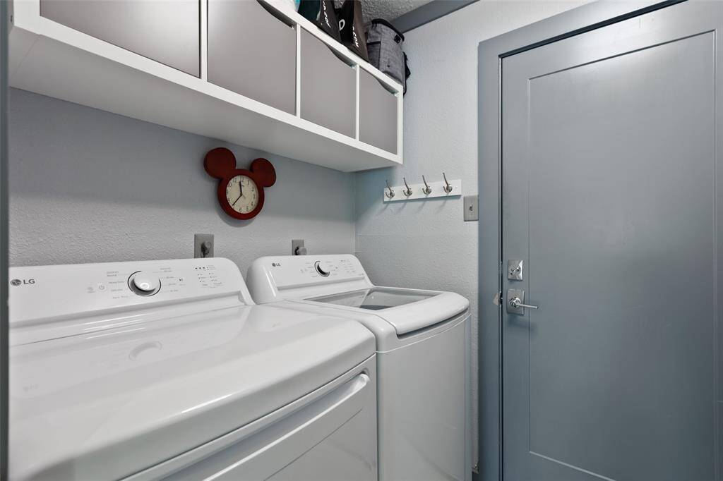 The laundry room has custom storage and access to the garage.