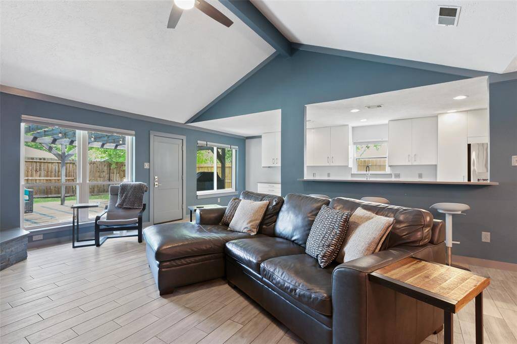 The home features wood like tile throughout. There is updated recessed in the living room.
