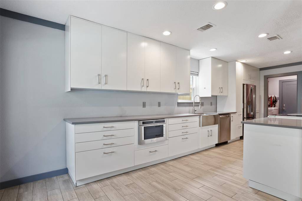 The kitchen is completely updated with quartz counter tops and custom cabinets.