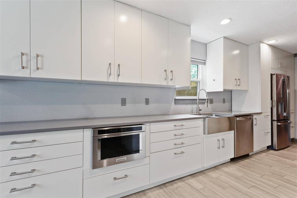 The kitchen boasts stainless steal appliances and ample counter space.