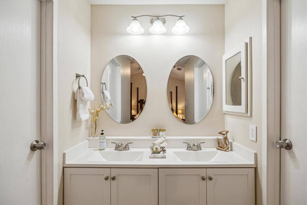 The Primary en-suite bathroom features a sleek new vanity with dual sinks.