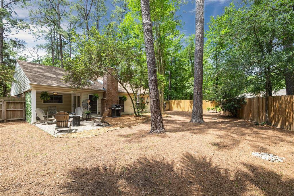 The low-maintenance backyard is laid with playground mulch, making it safe to play and enjoy the outdoors without all the upkeep.