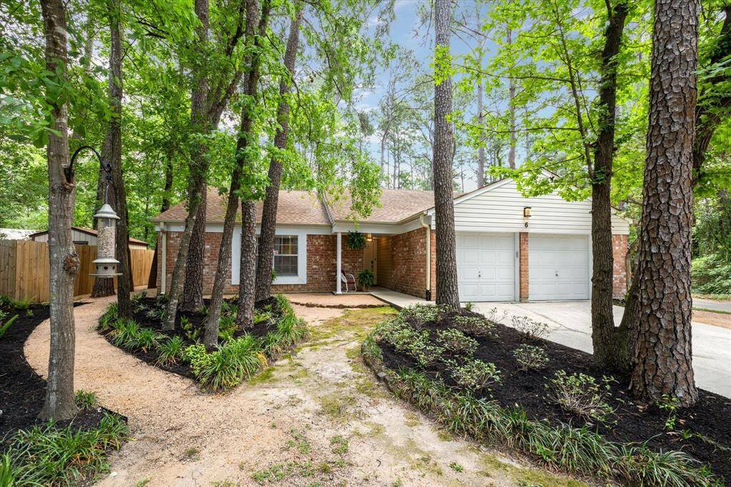 Step back and take it all in. Privacy and presence under the sky-high trees. This house leaves a lasting impression.
